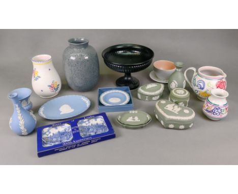 Two Poole Pottery vases and a jug painted with flowers, a Poole Pottery black speckled grey vase and two other pieces, and a 
