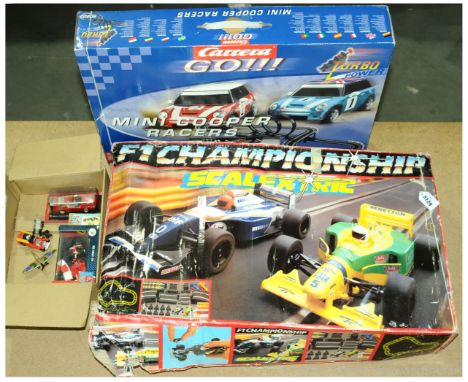 A mixed group to include 2x Scalextric sets F1 Championship Scalextric &amp; Carrera Go Mini Cooper Racers Set, boxed Hot Whe