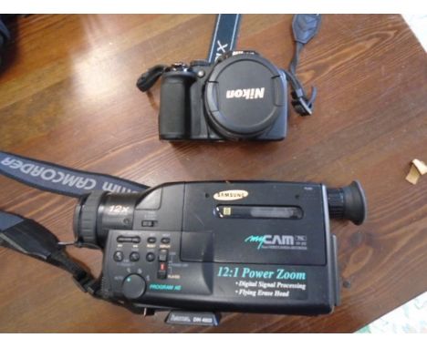 Nikion coolpix P530 camera and a Samsung video camera recorder, all with power packs in a canvas bag