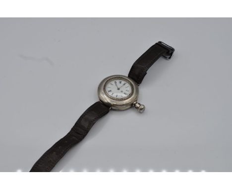  EARLY WRIST WATCH (conversion from a pocket watch) silver case design, white enamel face , 45mm case size, side winding sold
