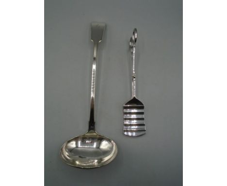 A white metal ladle and a pair of silver plated asparagus tongs. 335g gross weight