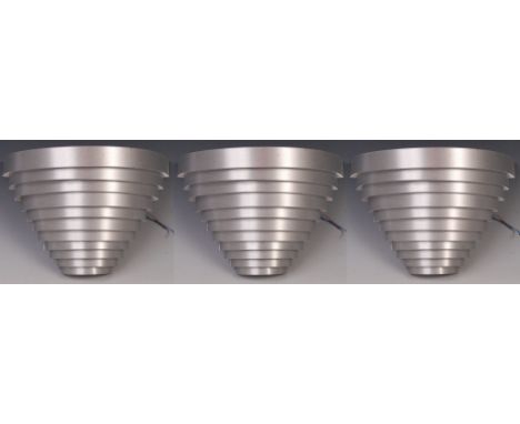 A set of three of contemporary designer ' Eclipse ' wall light / sconces having curved brushed sheet aluminium graduating in 