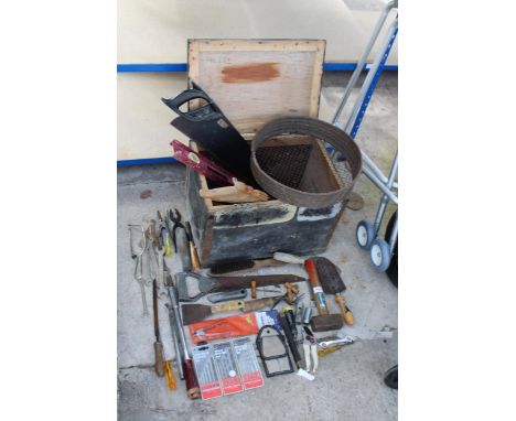 A WOODEN TOOL CHEST WITH AN ASSORTMENT OF HAND TOOLS TO INCLUDE SPANNERS, HAMMERS AND SAWS ETC 