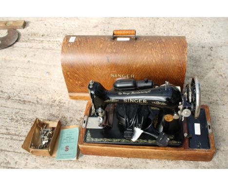 A VINTAGE SINGER SEWING MACHINE WITH WOODEN CARRY CASE, MANUAL AND SPARE PARTS ETC 