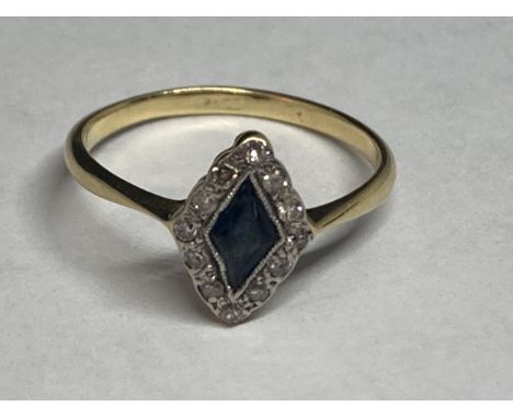 A 9 CARAT GOLD RING WITH A DIAMOND SHAPED SAPPHIRE SURROUNDED BY DIAMONDS SIZE J/K 