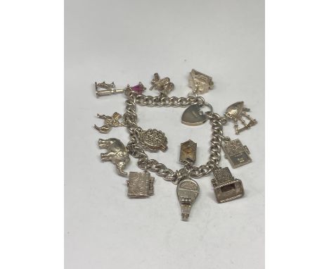 A SILVER CHARM BRACELET WITH TWELVE CHARMS 