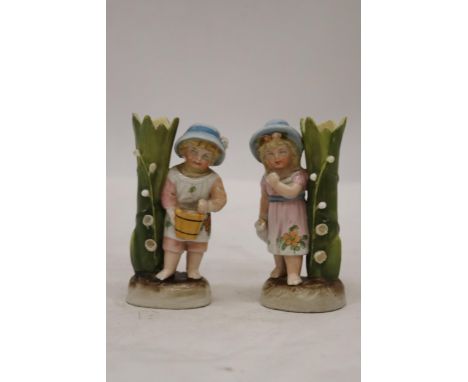 TWO VINTAGE GERMAN FAIRINGS TO INCLUDE A GIRL WITH JUG VASE AND A GIRL WITH BASKET VASE GOOD COLOURS TO BOTH - APPROX 11CM 