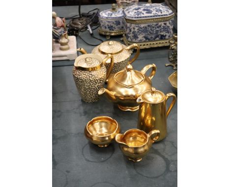 A GILT ROYAL WINTON TEAPOT, CREAM JUG AND SUGAR BOWL, ROYAL WORCESTER WATER JUG, PLUS A PATTERNED TEAPOT WATER JUG AND TEAPOT