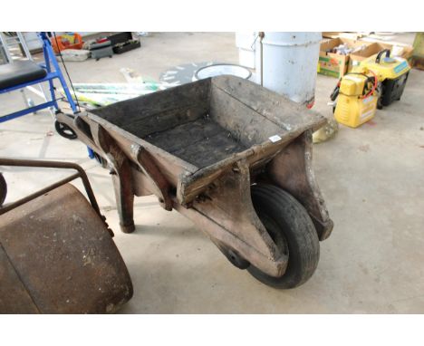 A WOODENGARDEN WHEEL BARROW PLANTER WITH RUBBER TYRE 