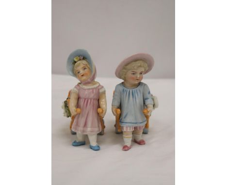 TWO VINTAGE GERMAN FAIRINGS TO INCLUDE TWO GIRLS PULLING FLOWER CARTS, ONE WITH A HAT, THE OTHER WITH A BONNET, GOOD COLOURS 