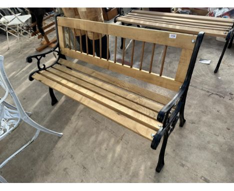A WOODEN SLATTED GARDEN BENCH WITH CAST BENCH ENDS 