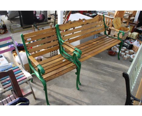 A WOODEN SLATTED GARDEN BENCH AND CHAIR BOTH WITH CAST ENDS 