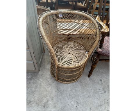 A VINTAGE WICKER BARREL CHAIR 