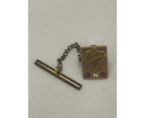 A HALLMARKED 9CT GOLD DIAMOND AND RUBY 'FODEN' PIN BADGE GROSS WEIGHT 4.84G 
