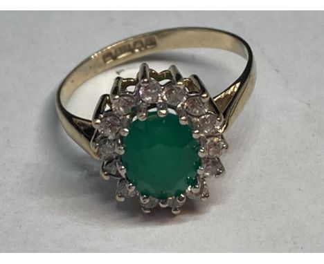 A 9 CARAT GOLD RING WITH CENTRE GREEN STONE SURROUNDED BY CUBIC ZIRCONIAS SIZE K 