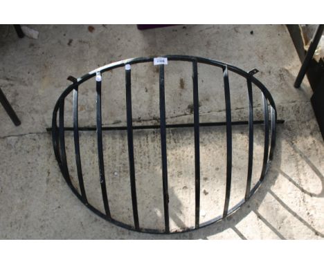 A METAL HAYRACK PLANTER 