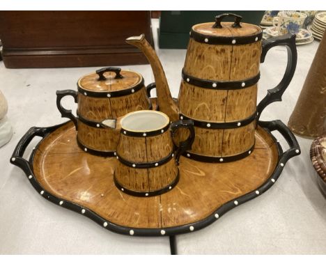 A CERAMIC TEASET ON A TRAY TO INCLUDE A COFFEE POT, SUGAR BOWL AND CREAM JUG, IN A BARREL STYLE DESIGN 