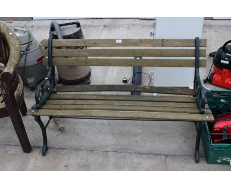 A WOODEN SLATTED GARDEN BENCH WITH CAST ENDS 
