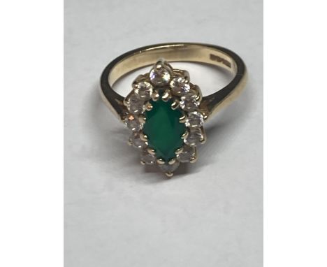 A 9 CARAT GOLD RING WITH A CENTRE EMERALD SURROUNDED BY CUBIC ZIRCONIAS SIZE L 