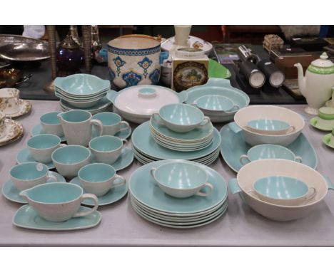 A POOLE POTTERY DINNER SERVICE TO INCLUDE SERVING DISHES, BOWLS, VARIOUS SIZES OF PLATES, SOUP COUPES, A SAUCE BOAT AND SAUCE