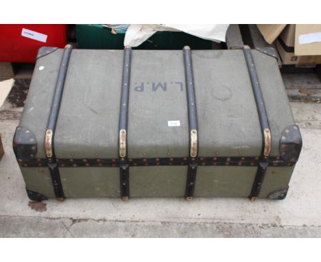 A VINTAGE COMPRESSED FIBRE TRAVEL TRUNK BEARING THE INITIALS L.M.P 