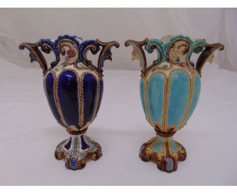 Two continental ceramic vases of lobed oval form with scrolling side handles on raised quatrefoil bases, 19cm (h)