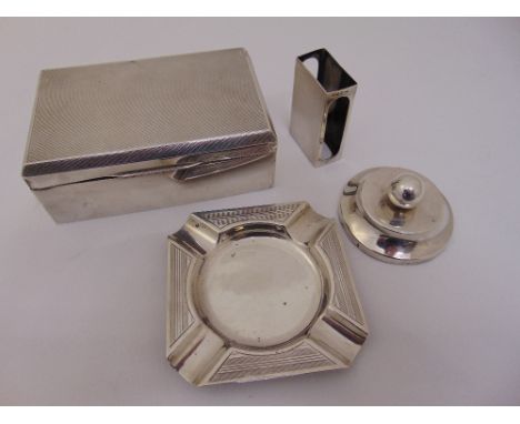 A quantity of silver to include a silver cigarette box London 1937, a silver hallmarked ashtray, a matchbox holder and a pape