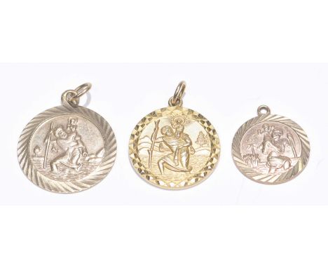 Three 9ct gold St. Christopher pendantsEach with engine turned surround. Lengths: 1.6 to 2cm. Weight approx. 6.8g.