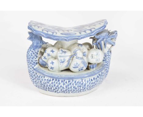 A Chinese blue and white porcelain head restThe upper shaped panel rest detailed with dragons within fire scrolls extending t
