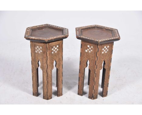 A pair of Middle Eastern inlaid occasional tablesThe hexagonal tops raised on six arcaded and chequerboard design panels, det