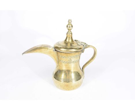 A Middle Eastern Islamic dallah coffee pot, 19th Century  The incised brass pot with hinged cover, loop handle, and elongated