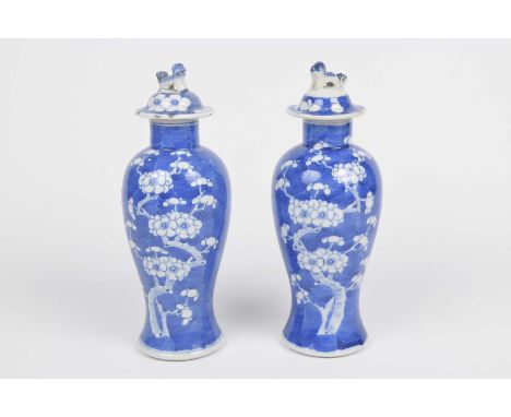 A pair of Chinese blue and white 'Prunus' vases and covers Each of shouldered form, rising to the upright beck, surmounted by