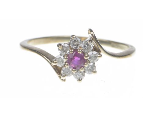 A 9ct gold ruby and diamond cluster ring.The circular-shape ruby within a brilliant cut diamond surround. Diamond weight: 0.2