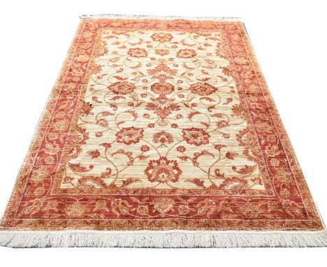 A Ziegler style rugThe red and ochre ground with large central panel with foliate designs picked out with gold threads set be