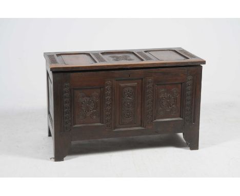 A 17th Century style  carved oak cofferHaving an invert moulded three panel top above three conforming front panels each carv