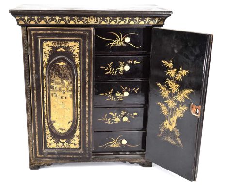 A Chinese black lacquered table cabinet, late 19th CenturyThe bevelled top extending to scroll bracket feet, the twin hinged 