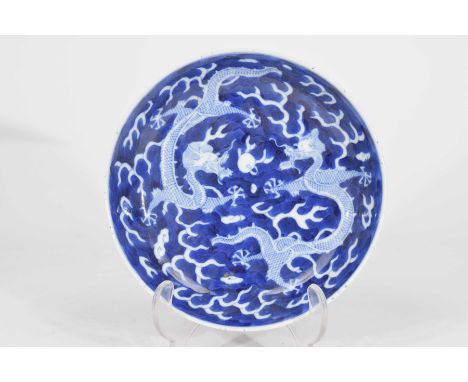 A Chinese blue and white 'dragon dish' Qianlong six character mark (1736-95) 19th/20th Century The circular dish with deep we