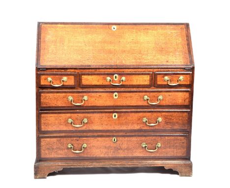 An impressive George III oak and mahogany cross banded bureauThe cross banded fall front enclosing a compartmentalised interi