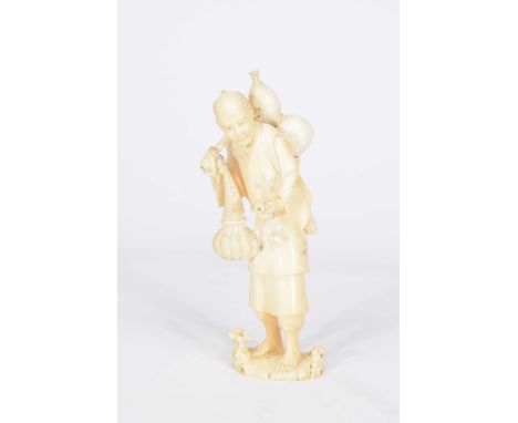 A Japanese carved ivory okimono, late Meiji period (1868-1912)The farmer modelled with gourd to his back, small tortoise in h