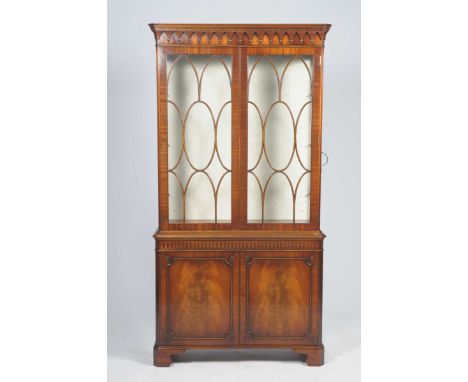 A Reprodux by Bevan Funnell Georgian style mahogany bookcaseHaving a moulded dentil cornice above two astragal glazed doors e