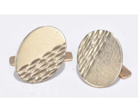 A pair of 9ct gold cufflinksEach designed as an oval shape panel with T-clasp, in fitted case. Hallmarks for Birmingham. Leng