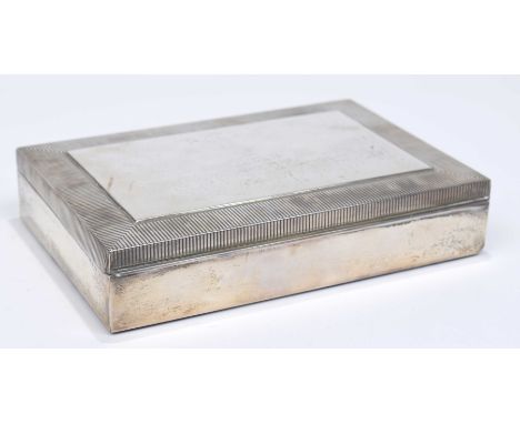 A white metal cigar boxOf rectangular outline, with engine turned border, with hinged lid and wooden interior. Stamped Sterli