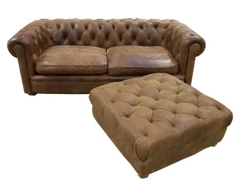 A stunning contemporary tan leather Chesterfield leather setteeThe deep set button back and padded arms enclosing a pair of l