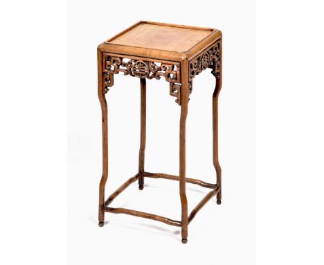 A Chinese Huanghuali style jardiniere stand The tubular yoke form supports united by a lower stretcher, with carved ruyi scro