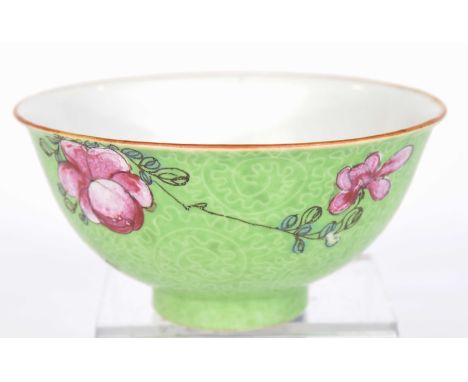 A Chinese green glazed famille rose bowl, late Qing Dynasty (1644-1912)The green scrolling incised sides, picked out with pin