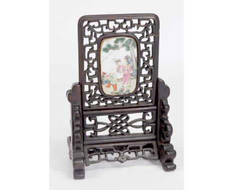 A Chinese 19th Century hardwood and famille rose porcelain table screenThe pierced frame raised on swept member supports, enc