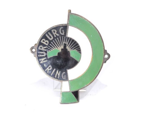 A metal and enamel Nurburg Ring car badge, mid 20th CenturyThe black, white and green badge with an image of the Nurburg Ring