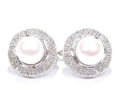 A pair of silver cultured pearl and diamond earrings.Each designed as a cultured pearl within a single-cut diamond surround. 