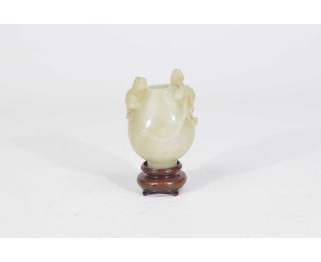 A Chinese green jade/nephrite snuff bottle, 19th Century The globular body raised on high foot ring, carved with depictions o