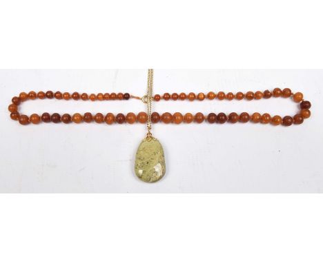 An amber style bead necklaceThe graduated amber style beads with spring clasp, together with an unakite pendant on chain, len
